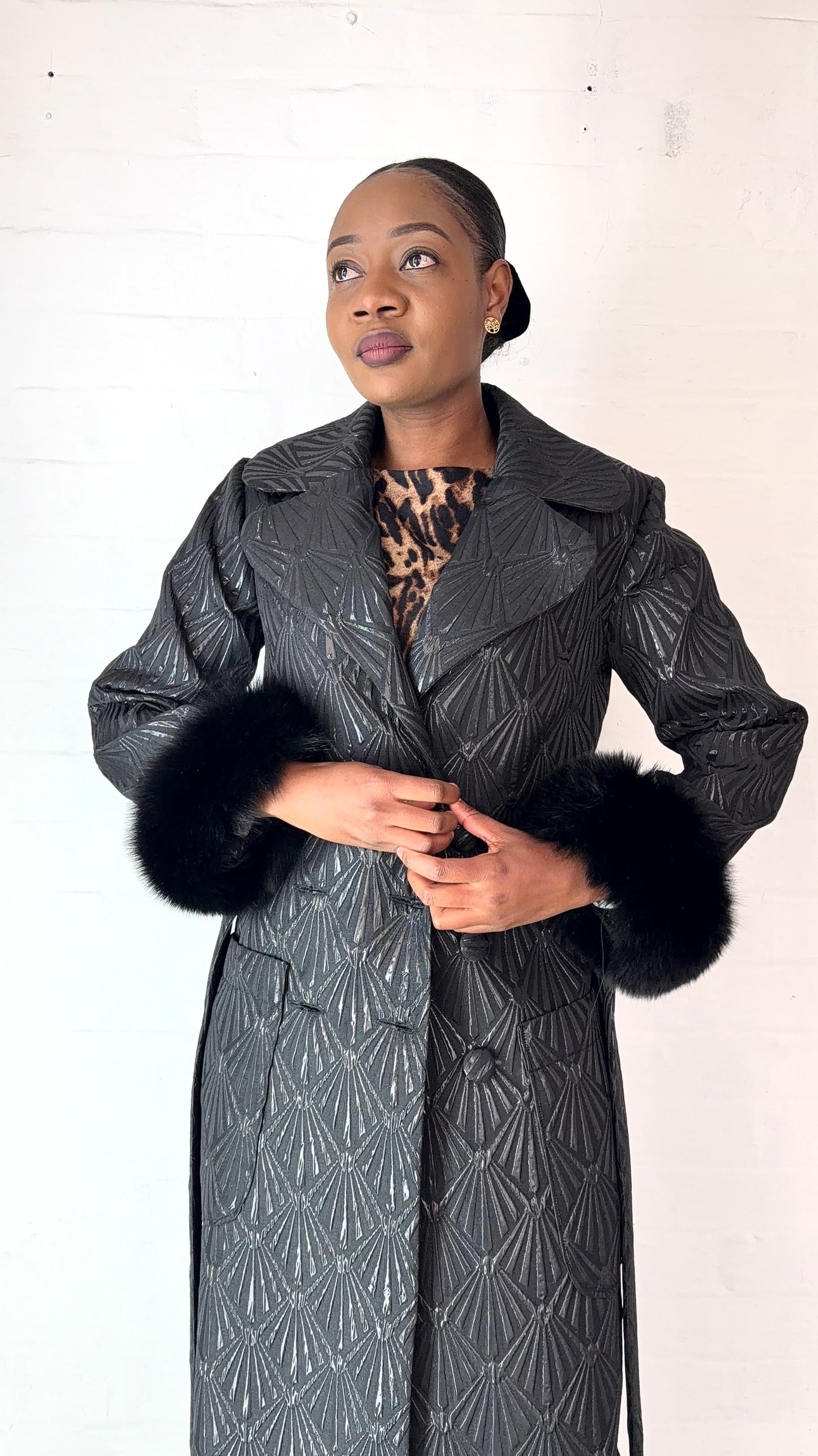 Black brocade coat by Thula Sindi