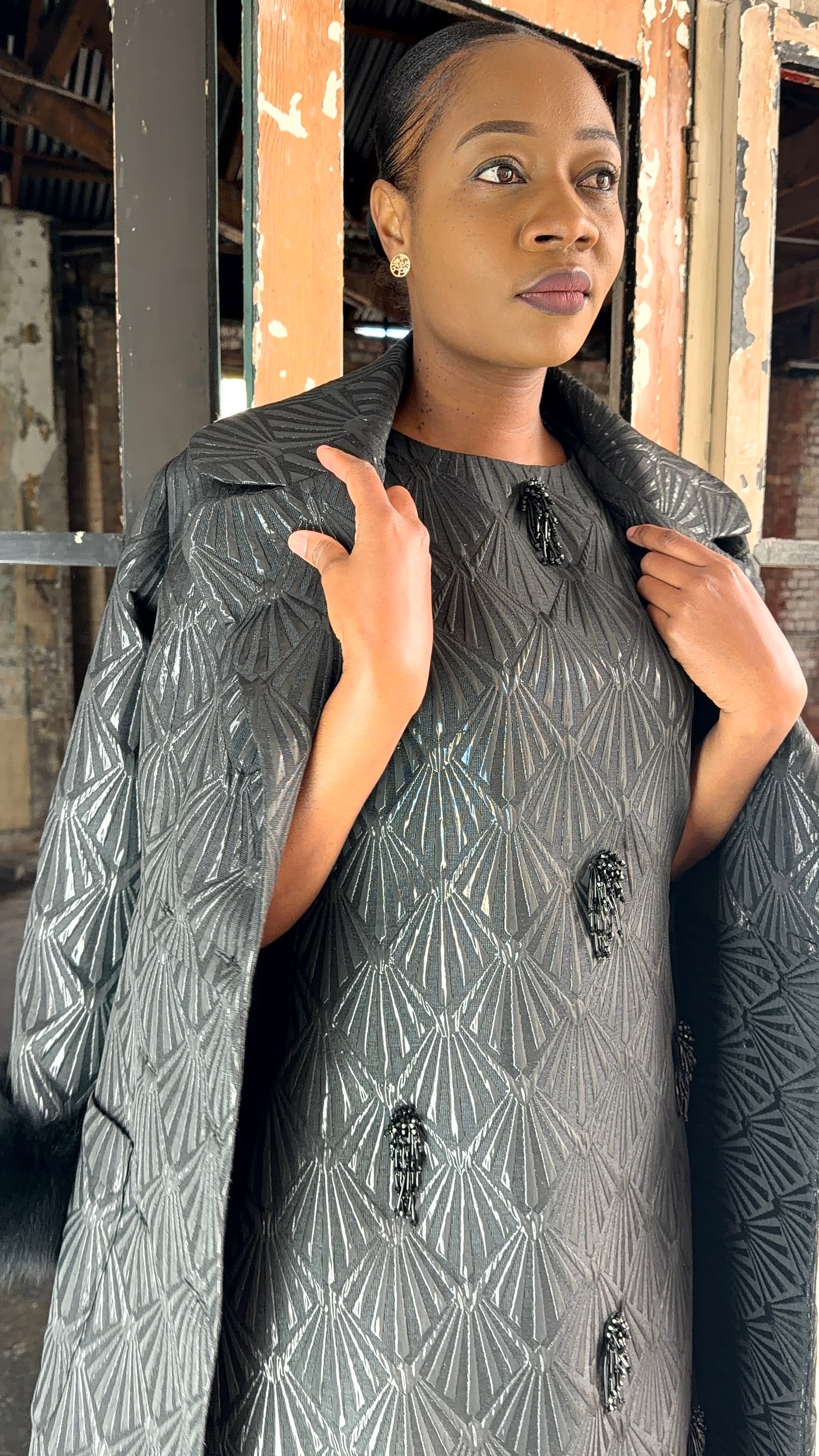 Black brocade coat by Thula Sindi